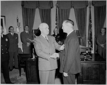 President Truman presents a Medal of Merit to Secretary of Defense James Forrestal in the Oval Office. - NARA - 199640