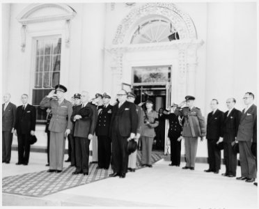 Prince Charles of Belgium and President Truman and other dignitaries stand at attention in the entranceway to the... - NARA - 199763