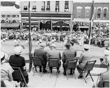 President Harry S. Truman and other dignitaries on the reviewing platform, watching a parade, in Bolivar, Missouri.... - NARA - 199906 photo