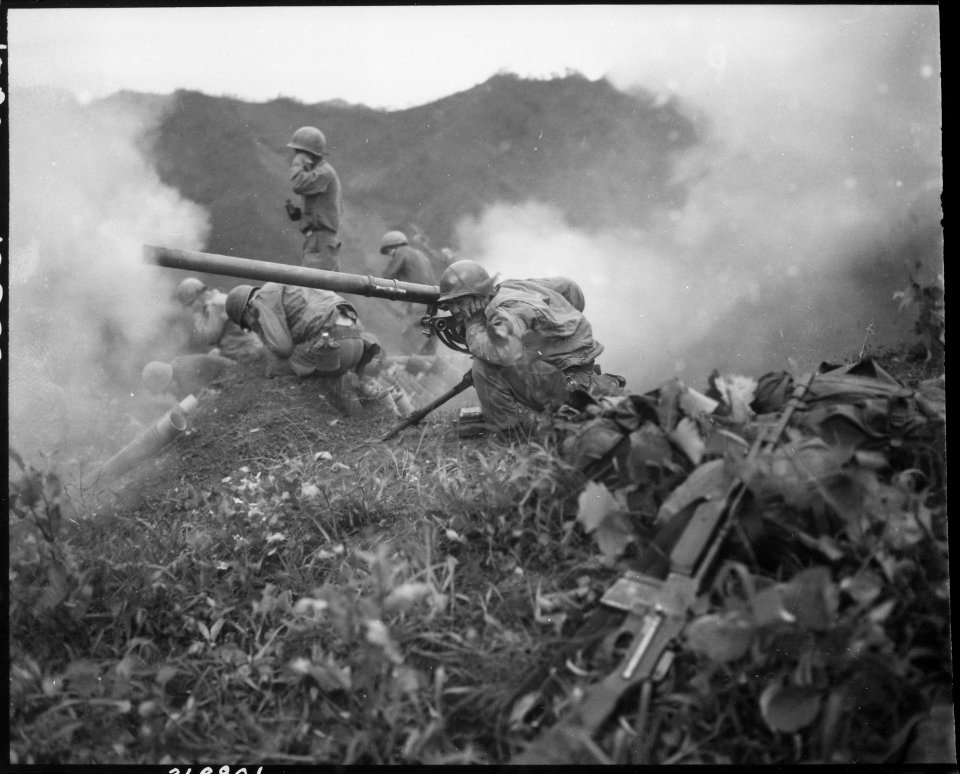 Private First Class Roman Prauty, a gunner with 31st Regimental Combat Team (crouching foreground), with the... - NARA - 531409