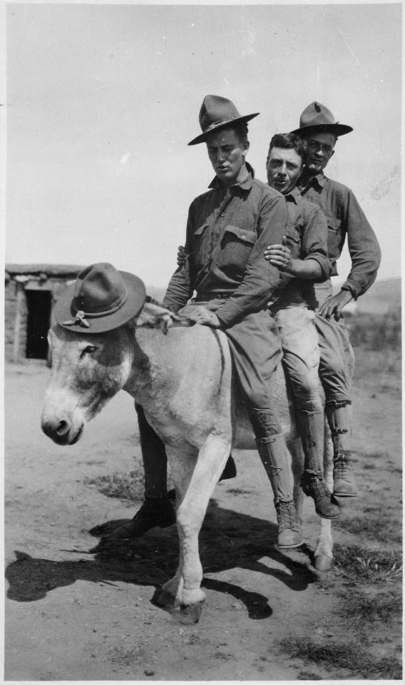 Privates Daly, Ball, and Baldwin, Company A, 16th Infantry, testing out the burro. This burro came to camp one day and e - NARA - 533146