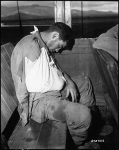 Private First Class, Orvin L. Morris, 27th Regiment, takes a much deserved rest during his evacuation to Pusan... - NARA - 531368 photo