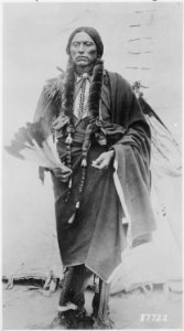 Quanah Parker, a Kwahadi Comanche chief, full-length, standing in front of tent - NARA - 530911