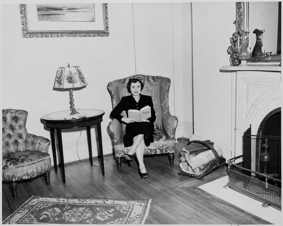 Reathel Odom, secretary to Bess Truman, sitting in a winged chair in the White House. - NARA - 199958