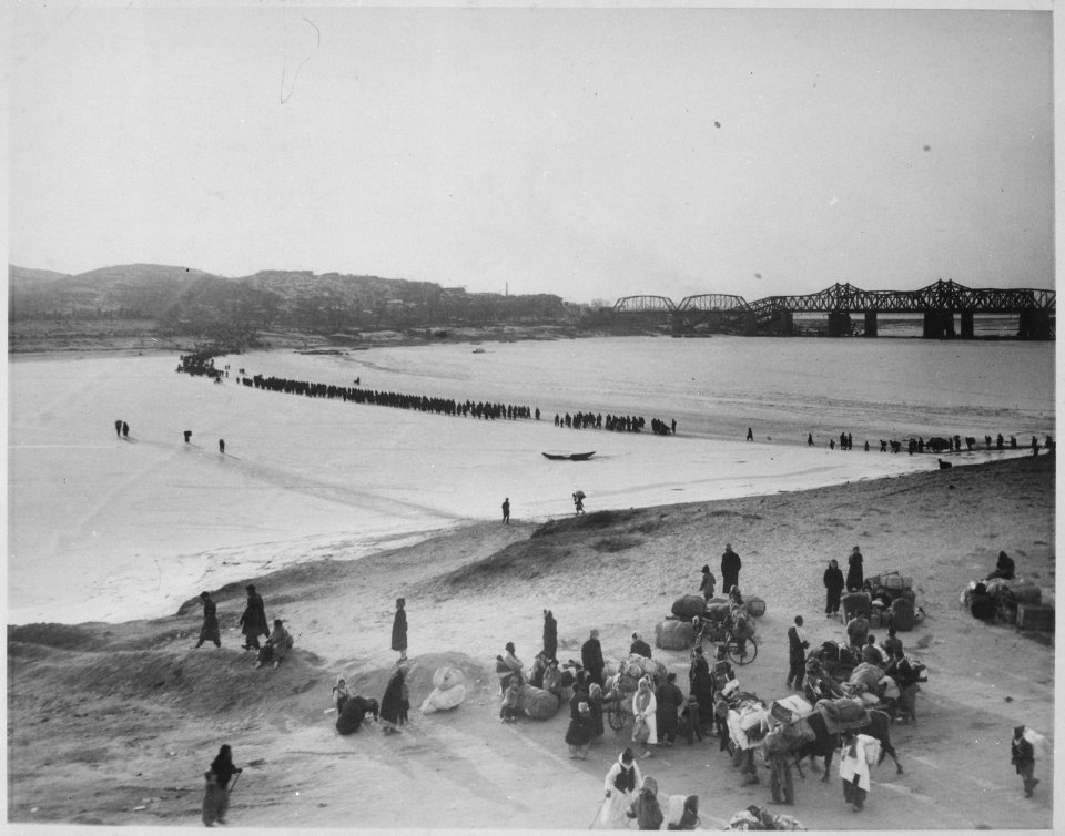 Refugees streaming across the frozen Han River on the ice as they flee southward before the advancing tide of Red... - NARA - 541965