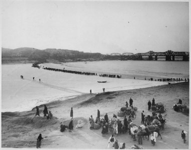 Refugees streaming across the frozen Han River on the ice as they flee southward before the advancing tide of Red... - NARA - 541965