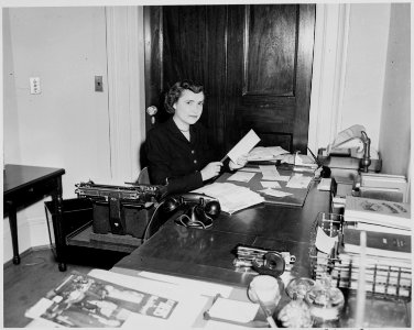 Reathel Odum, secretary to Bess Truman, working at her desk in the White House. - NARA - 199959