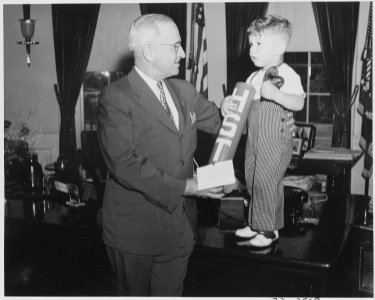 President Truman receives little Michael Gene Condatore of Washington in the oval office. Little Michael presented to... - NARA - 199723 photo