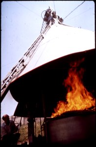 RESEARCH ASSOCIATE ERV MATEER OBSERVES THE BURNING OF WHEAT STRAW IN AGRICULTURAL BURNING TOWER; THE - NARA - 542658 photo