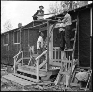 Rohwer Relocation Center, McGehee, Arkansas. Adding a front porch to their barracks, these centerit . . . - NARA - 538931
