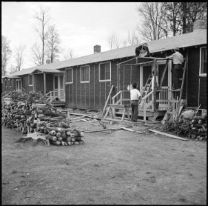 Rohwer Relocation Center, McGehee, Arkansas. A typical street scene. Wood for fuel is piled in the . . . - NARA - 538932