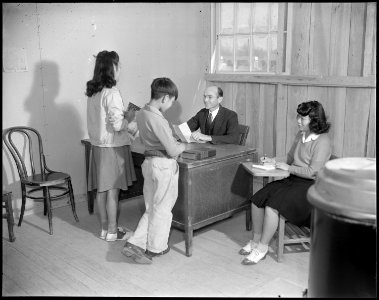 Rohwer Relocation Center, McGehee, Arkansas. John Bledsoe, Jr. High School Principal, his secretary . . . - NARA - 538968