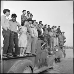 Rohwer Relocation Center, McGehee, Arkansas. Part of a crowd of evacuees watching a football game b . . . - NARA - 538889
