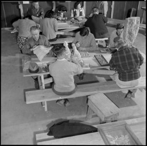 Rohwer Relocation Center, McGehee, Arkansas. In a wood carving class, at the Rohwer Relocation Cen . . . - NARA - 539389 photo