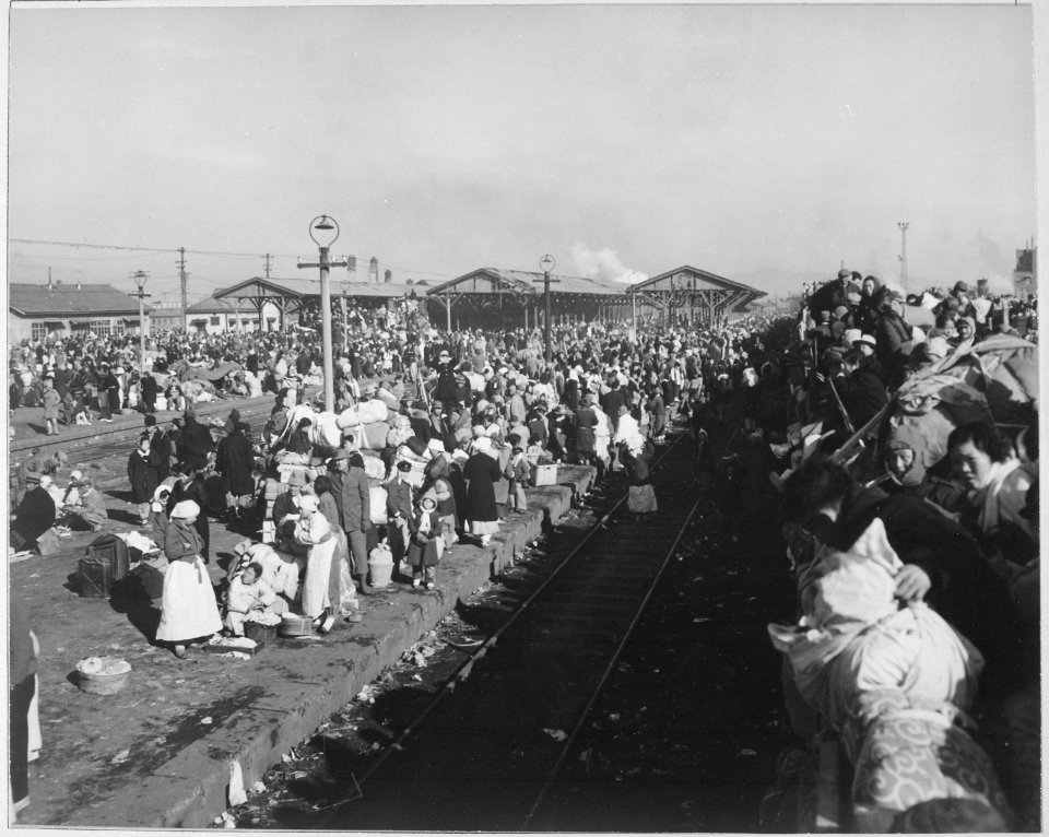 Refugees crowd railway depot at Inchon, Korea, in hopes they may be next to get aboard for trip further south and... - NARA - 520784