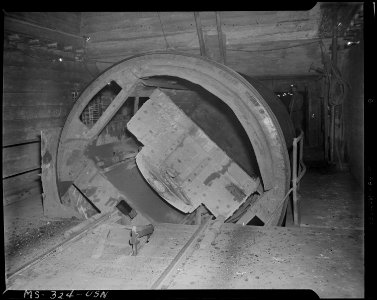 Rotary unloader for loaded shuttle car. Coal is dumped into bin underneath unloader. Pyramid Coal Company, Victory... - NARA - 540356 photo