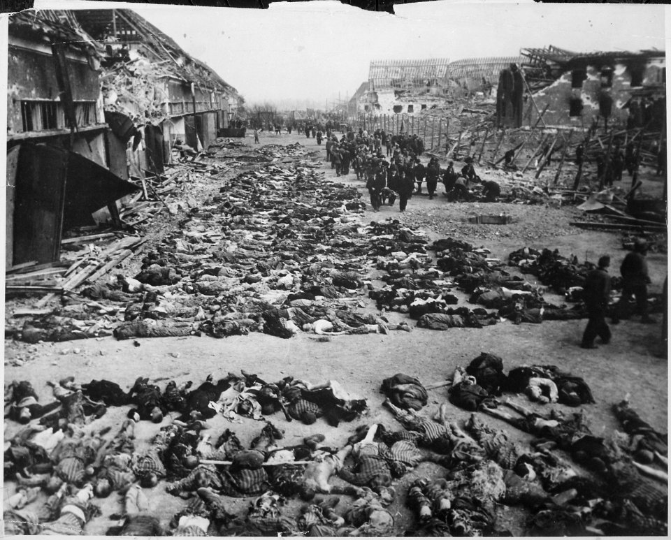 Rows of bodies of dead inmates fill the yard of Lager Nordhausen, a Gestapo concentration camp. This photo shows less... - NARA - 531259
