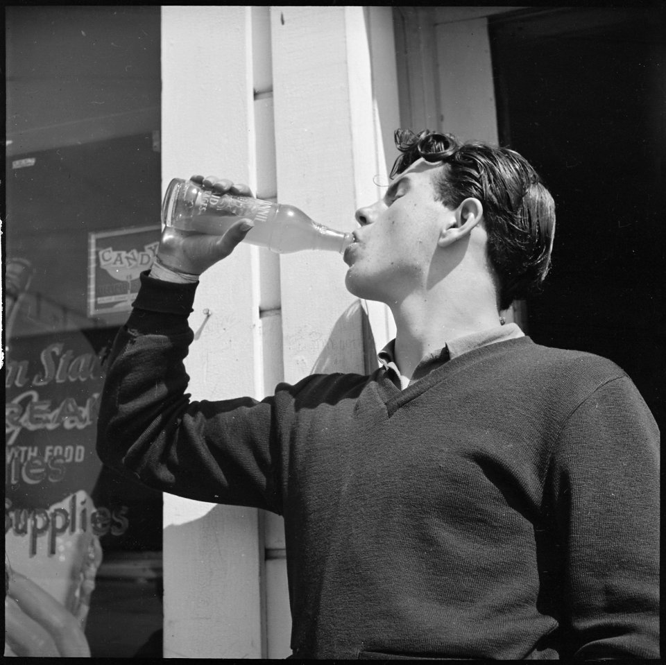 Roosevelt High School, Oakland, California. High School Youth. The inevitable bottle of pop - the beverage of... - NARA - 532221