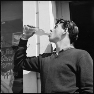 Roosevelt High School, Oakland, California. High School Youth. The inevitable bottle of pop - the beverage of... - NARA - 532221 photo