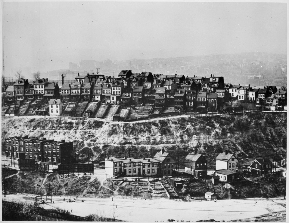 Rows of frame houses in a hilly area of Pittsburgh, with the smoke-shrouded city in the background, ca. 1940 - NARA - 518066