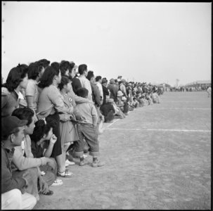 Rohwer Relocation Center, McGehee, Arkansas. A crowd of evacuees watching a football game between t . . . - NARA - 538920