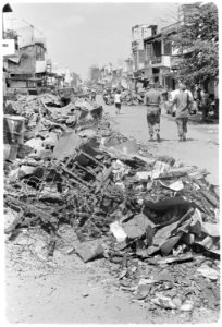 Saigon, Vietnam....Rubble and the remains of barbed wire line the streets of Cholon, a suburb of Saigon that was... - NARA - 558530 photo