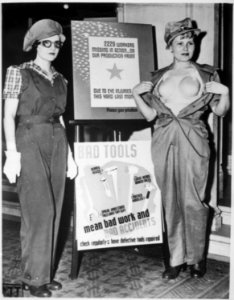 Safety garb for women workers. The uniform at the left, complete with the plastic bra on the right, will prevent... - NARA - 522882