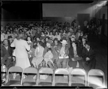 Salinas, California. Seated in family groups, evacuees of Japanese ancestry check in at Armory befo . . . - NARA - 536188
