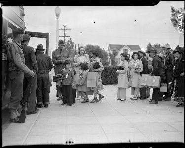 Salinas, California. Evacuees of Japanese ancestry boarding a bus which will take them to the Santa . . . - NARA - 536186