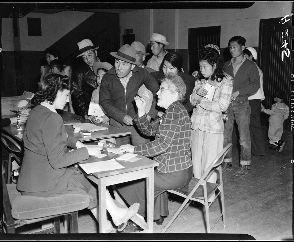 Salinas, California. The head of a family of Japanese descent checks in with clerks at this assembl . . . - NARA - 536189
