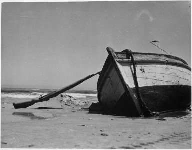 Row boat and rifle left on the beach of Cap Bon by the Germans. Tunisia, circa May 1943. - NARA - 540071