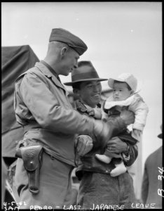 San Pedro, California. Father and son evacuees of Japanese ancestry talk things over with a militar . . . - NARA - 536783 photo