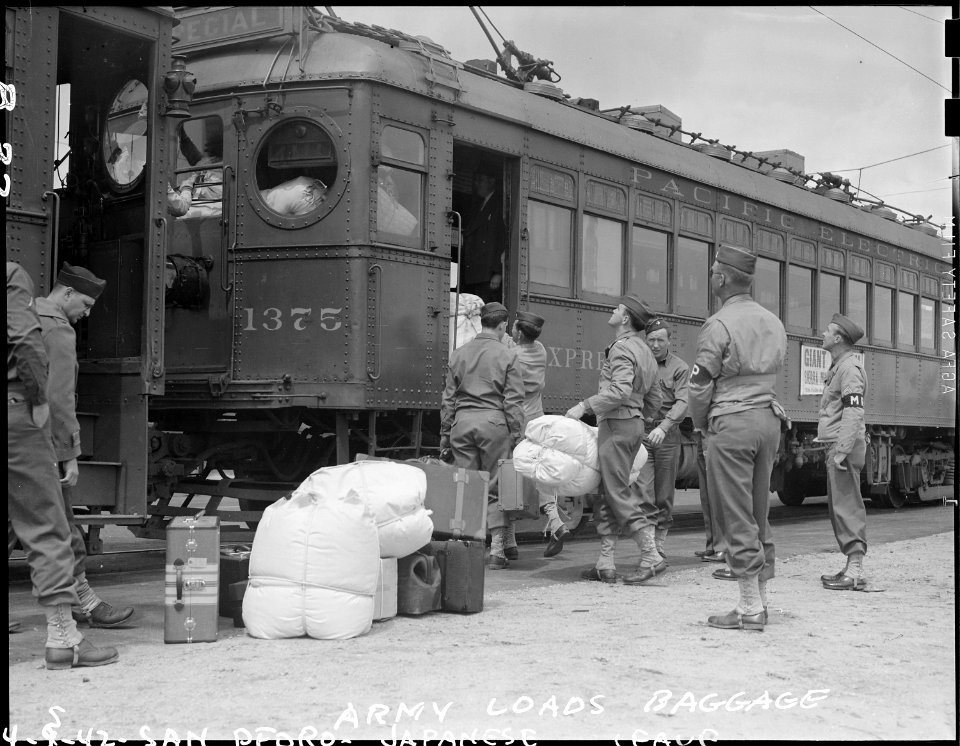 San Pedro, California. Army military police load the last baggage belonging to evacuees of Japanese . . . - NARA - 536781