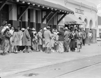 San Pedro, California. Evacuees of Japanese ancestry waiting for the train which will take them to . . . - NARA - 536003 photo