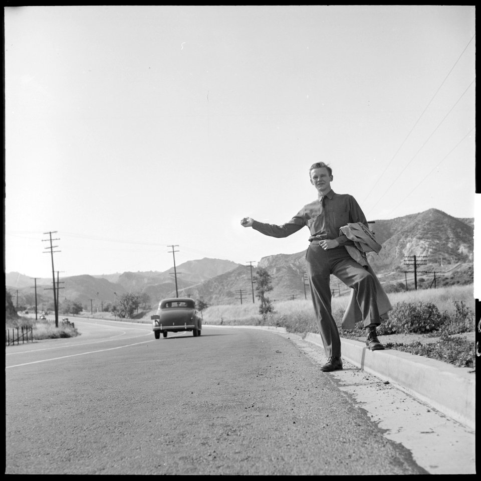 San Fernando, California. Hitch-hiking. This Civilian Conservation Corps boy is returning to camp about thirty miles... - NARA - 532087