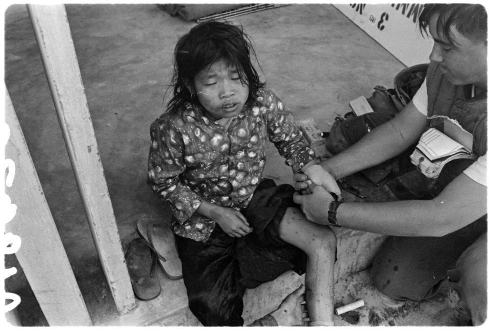 Small girl receives medical aid during fierce fighting in Nam-o Village near Danang, South Vietnam. - NARA - 532450