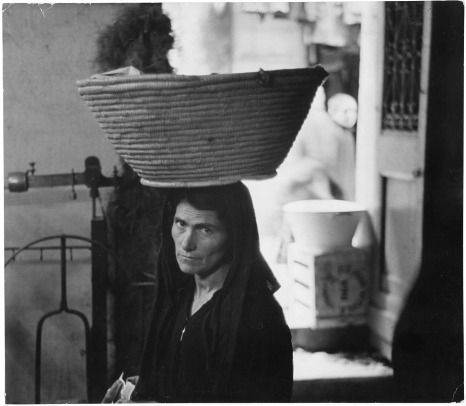 Sardinia, Italy. This peasant woman carrying a heavy basket on her head, comes into Iglesias from one of the out... - NARA - 541737