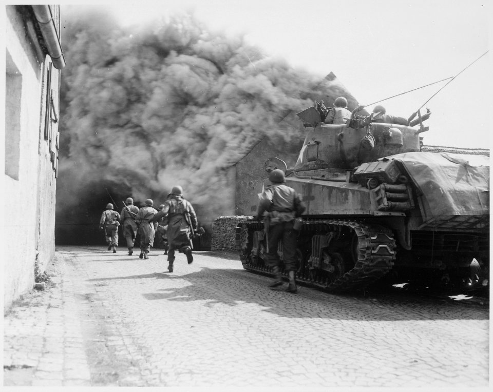 Soldiers of the 55th Armored Infantry Battalion and tank of the 22nd Tank Battalion, move through smoke filled... - NARA - 531278