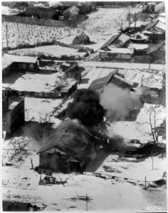 Smoke billows from Communist supply building at Sohung, Korea, after low level bombing raid by B-26s of the 452nd... - NARA - 542252