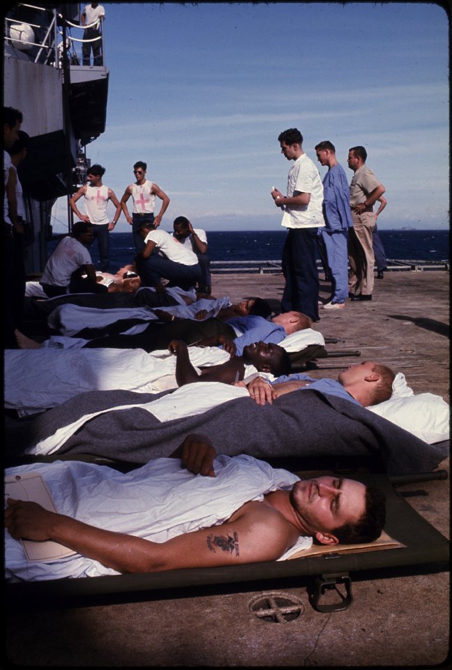 South Vietnam - Medical evacuation patients on the deck of the Amphibious assault ship USS Tripoli (LPH-10) await... - NARA - 558511