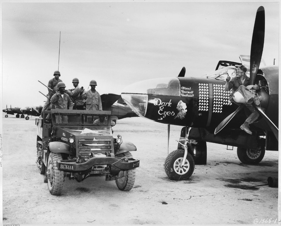 Sgt. Ben A. Robertson, Henderson, Texas, from his perch astride the propeller of this Fifth Air Force RB-26 light... - NARA - 542365
