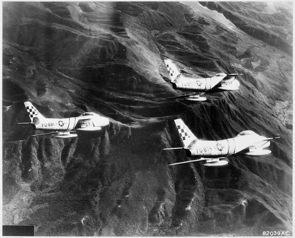 Streaking north over the rugged mountain territory of Korea, these U.S. Air Force F-86 Sabre jets of the 51st... - NARA - 542248