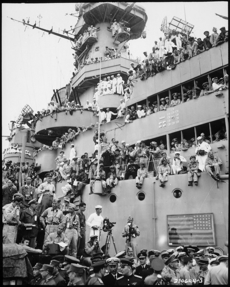 Spectators and photographers pick vantage spots on the deck of the USS MISSOURI in Tokyo Bay, to witness the formal... - NARA - 531312