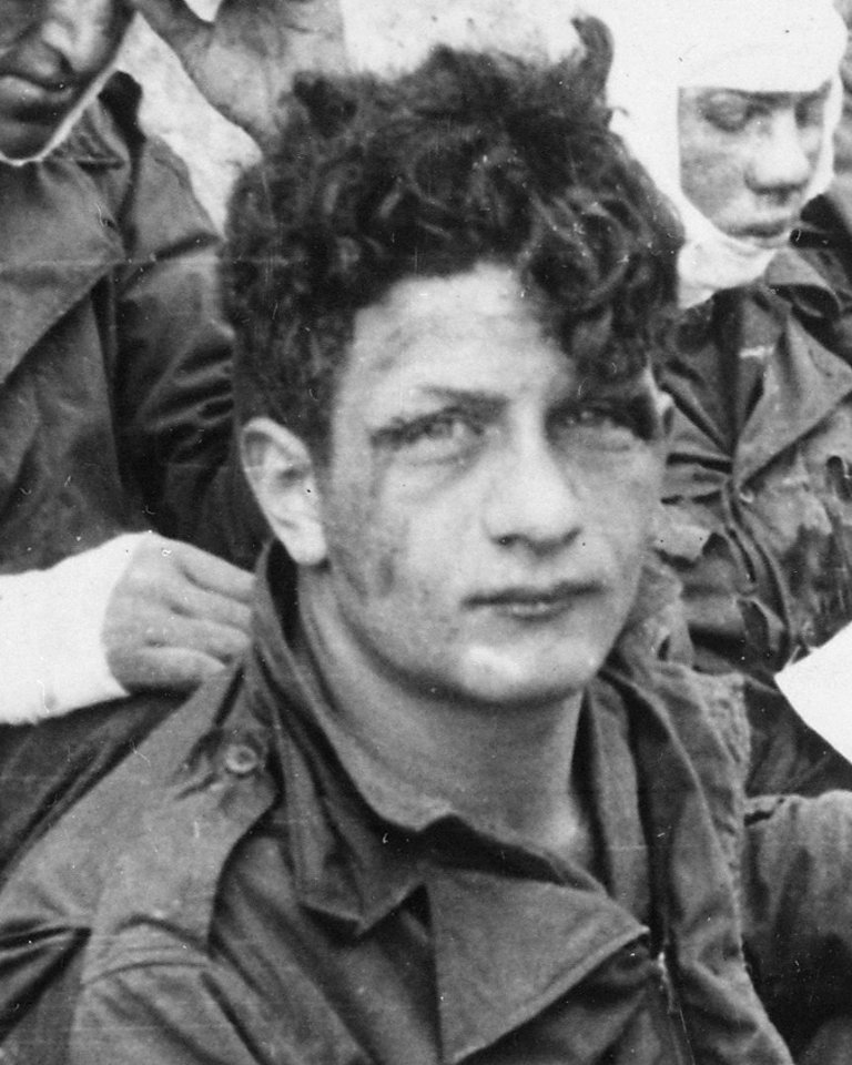Soldier face detail, from- American assault troops of the 16th Infantry Regiment, injured while storming Omaha Beach, wait by the Chalk Cliffs... - NARA - 531187 (cropped)