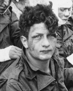 Soldier face detail, from- American assault troops of the 16th Infantry Regiment, injured while storming Omaha Beach, wait by the Chalk Cliffs... - NARA - 531187 (cropped) photo