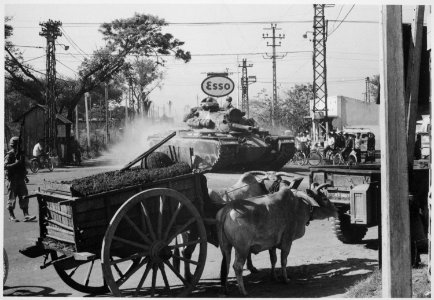 Tank from 1st Battalion, 69th Armor, 25th Infantry Division, moves through Saigon shortly after disembarking from LST at - NARA - 541873