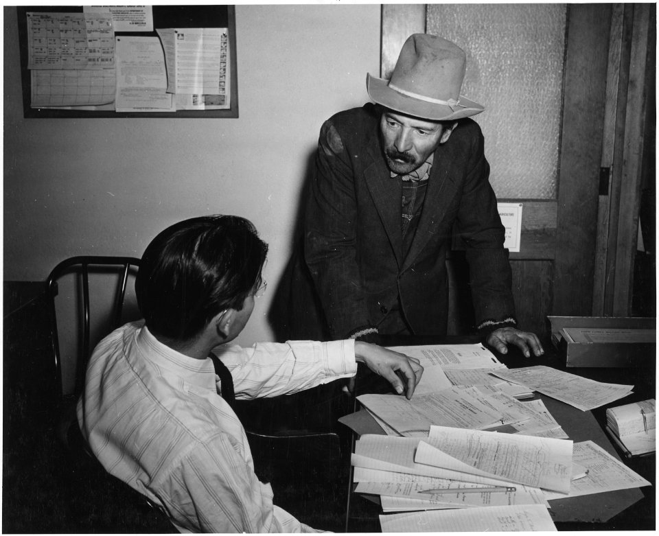 Taos County, New Mexico. Farm Security assistant supervisor and client, FSA office, Taos. - NARA - 521971