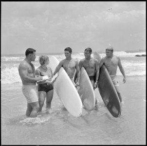 Surfing-Captain Rodney Bothelo, 1st Shore Party Battalion, and Miss Elli Vade Bon Cowur, Associate Director USO... - NARA - 532475
