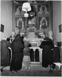 Taos County, New Mexico. Prayer before altar of church at Arroyo Seco. - NARA - 521929