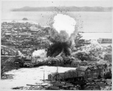 Supply warehouses and dock facilities at this important east coast port feel the destructive weight of... - NARA - 541959